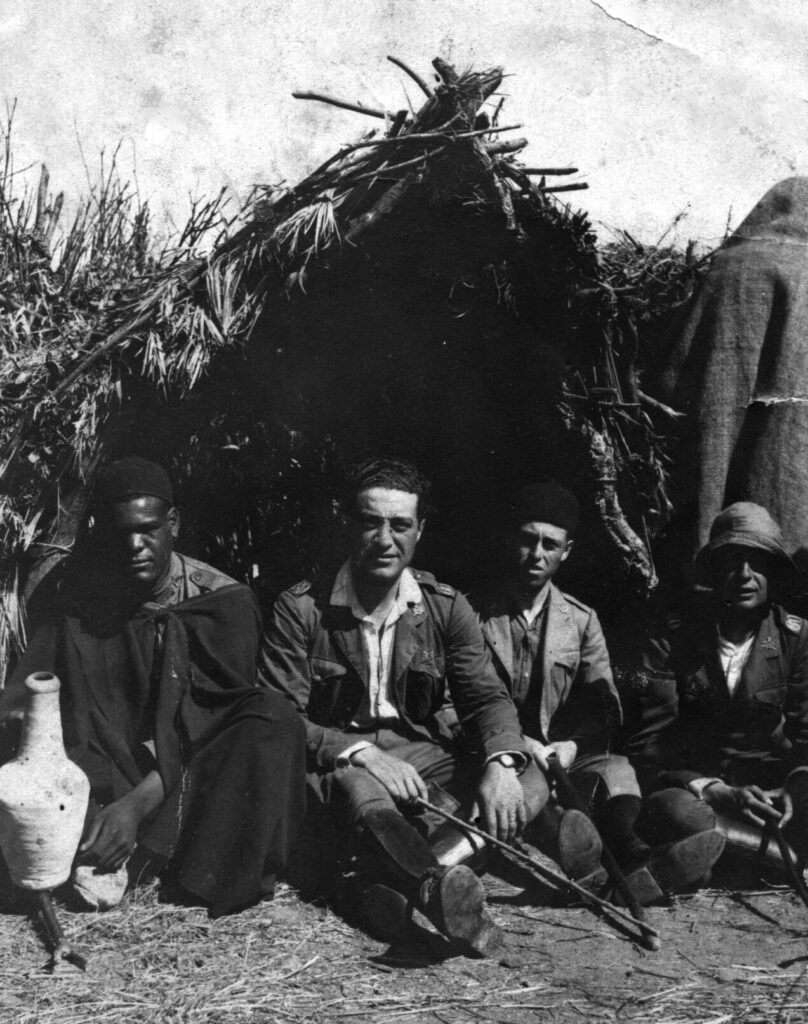 Cipri sitting next to a hut